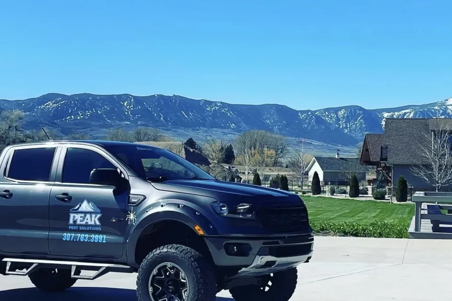 A Peak Pest Solutions outside of a Sheridan home
